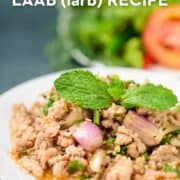a plate of pork laab with a mint garnish with text "authentic Thai laab (larb) recipe"