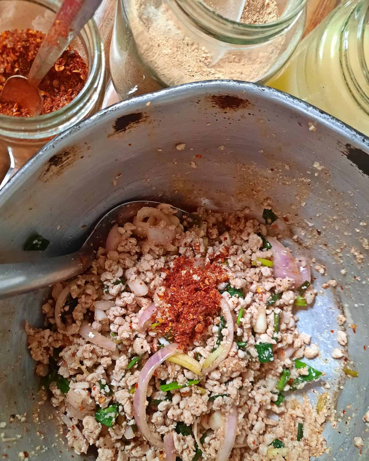 Laab being mixed in a pot