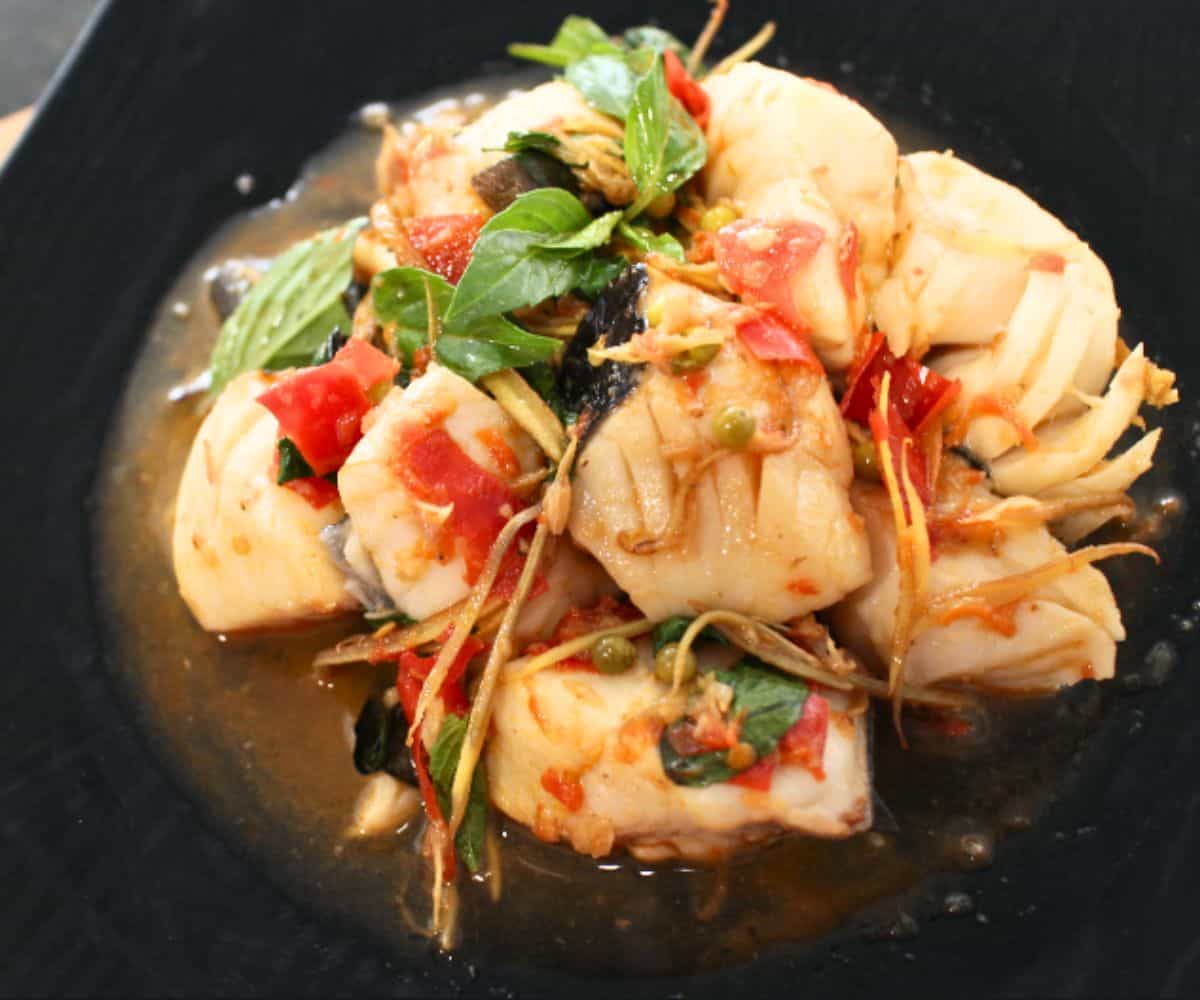 a plate of Thai fish and herbs stir fry