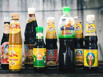 8 bottles of various sauces used in Thai cooking: soy sauces, oyster sauce, soybean paste, and fish sauce