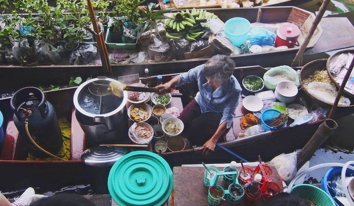 a boat noodle vendor on a boat in thailand