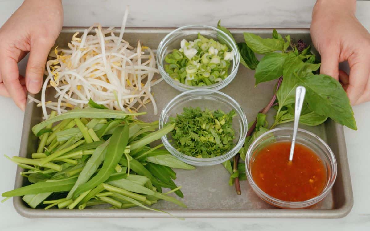 Toppings for boat noodles on a baking tray.