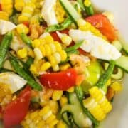 a plate of corn and cucumber salad