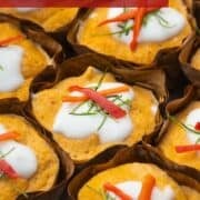 a bunch of haw mok in banana leaf cups with text overlay "thai steamed red curry"