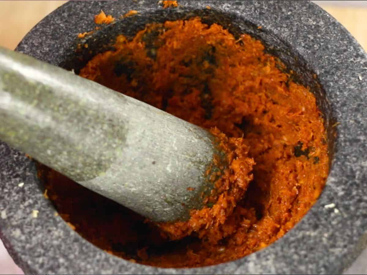 red curry paste in a mortar and pestle