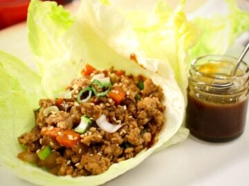 a plate of chicken lettuce wrap and a side of hoisin sauce