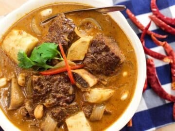 a bowl of massaman curry with beef