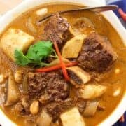 a bowl of massaman curry with beef