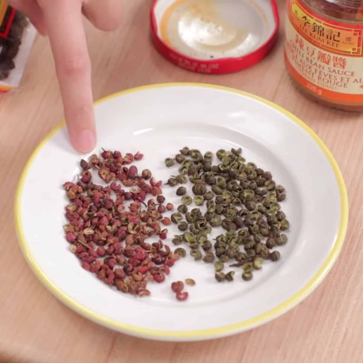 red and green sichuan peppercorns on a plate