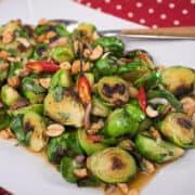 Add a little Thai flavour to your holiday table with this veggie side dish recipe! Brussel sprouts like you've never had—perfectly al dente, tossed with a spicy, garlicky, Thai dressing. Guaranteed to brighten up your Christmas dinner table! #Christmasrecipe #brusselsprouts #holidayrecipe #veggiesidedish #thairecipe #glutenfree