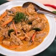 Panang is a popular classic Thai curry with a rich and luscious peanut sauce over tender beef that is super quick to make. I also share how to make semi-homemade panang curry paste using store-bought red curry paste as a base. An easy, delicious, gluten-free weeknight meal! #panangcurry #thaicurry #hotthaikitchen #Thairecipe #beefcurry