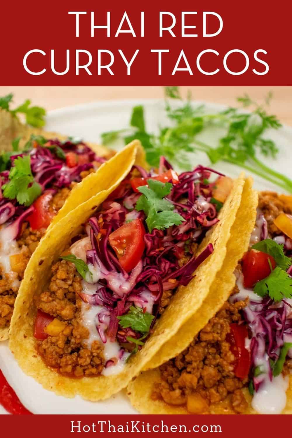 Unbelievably delicious Thai-inspired tacos filled with ground meat flavoured with red curry paste, topped with a crunchy Thai cabbage slaw and coconut crema. #thairecipe