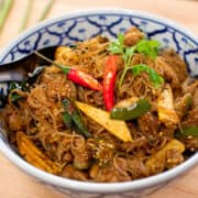 A bowl of Thai glass noodle stir fry with baby corn and thai eggplant