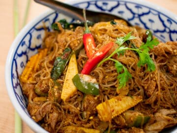 A bowl of glass noodle stir fry with curry paste