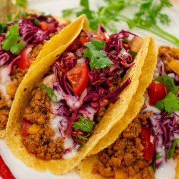 A plate of Thai tacos with cabbage slaw
