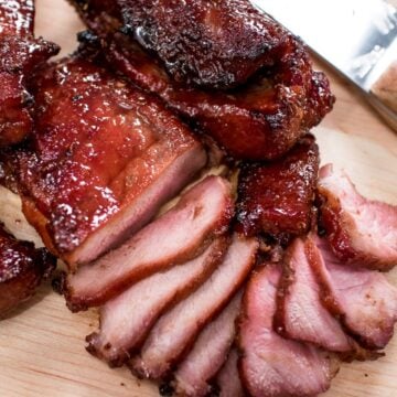 Sliced Chinese BBQ pork on a cutting board