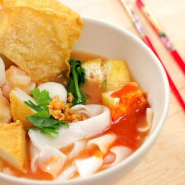 A bowl of yen ta fo noodle soups with chopsticks