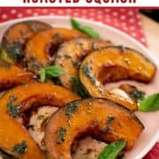A plate of roasted kabocha squash in slices with Thai basil garnish and basil oil drizzled on top.