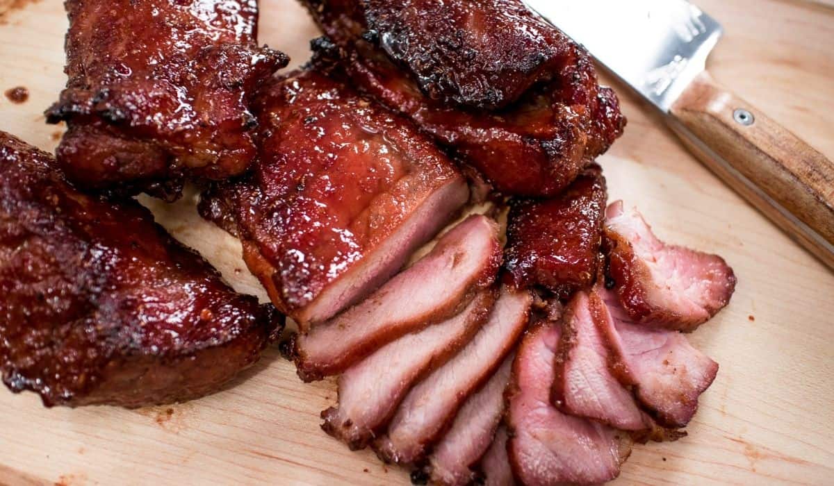 Chinese BBQ pork sliced on a cutting board.