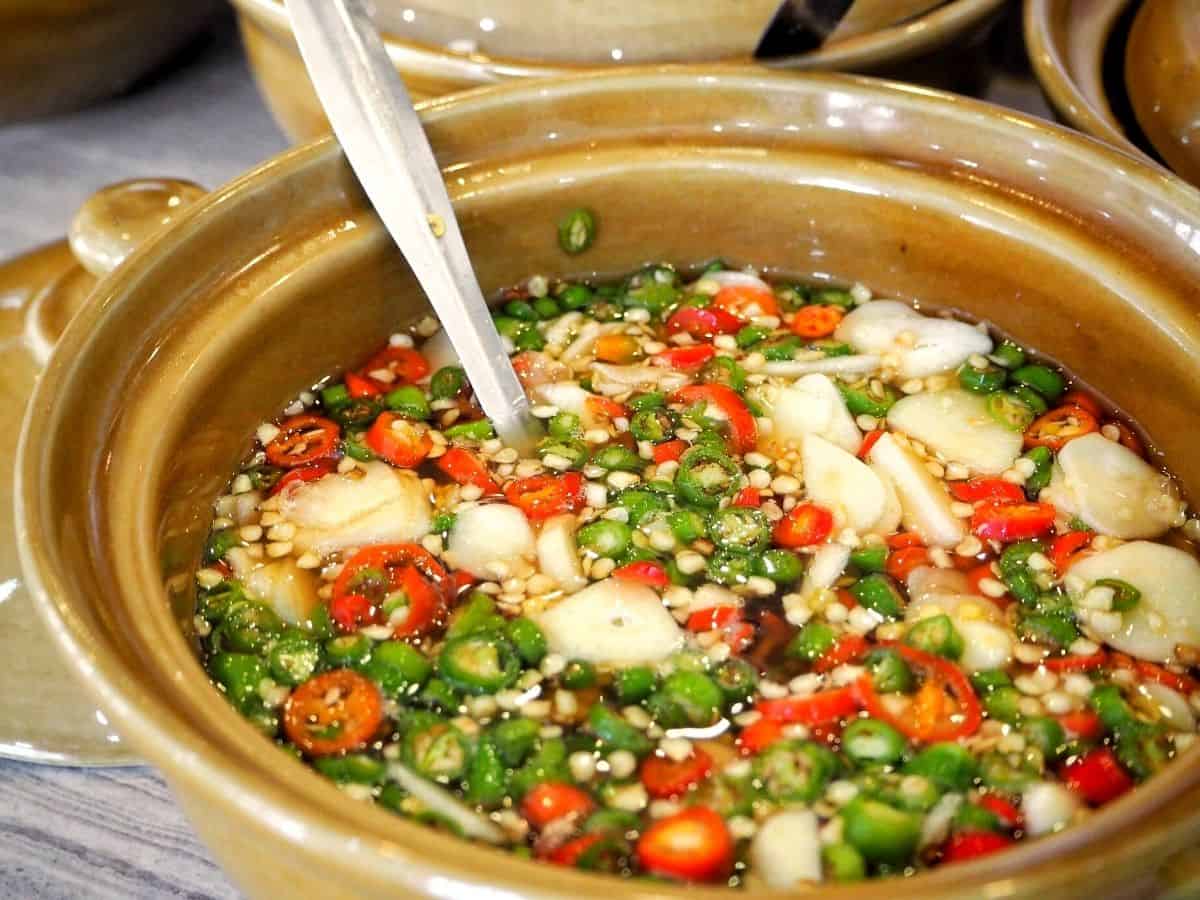 a bowl of fish sauce and chilies condiment