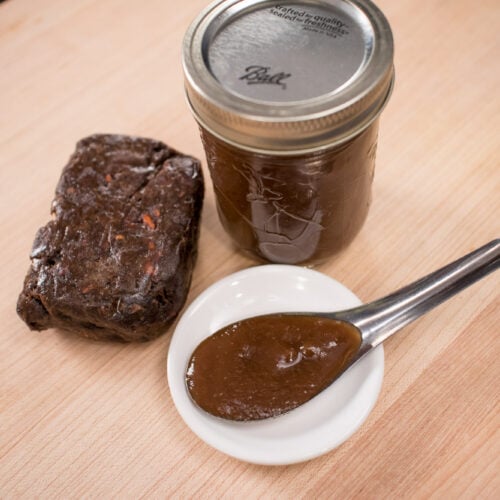 tamarind pulp block, tamarind paste in a jar, and tamarind paste in a spoon