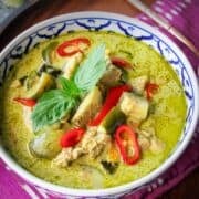 a bowl of green curry with text "authentic thai green curry chicken"