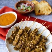 a plate of beef satay with peanut sauce with text over lay "beef satay & peanut sauce" and "hotthaikitchen.com"