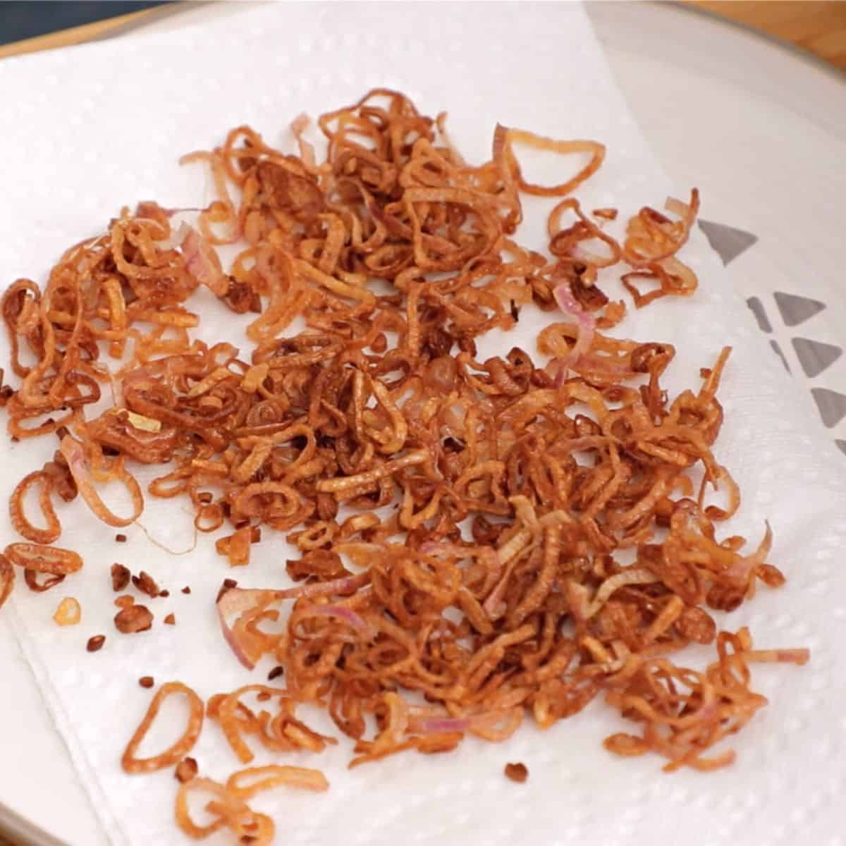 a plate of fried shallots