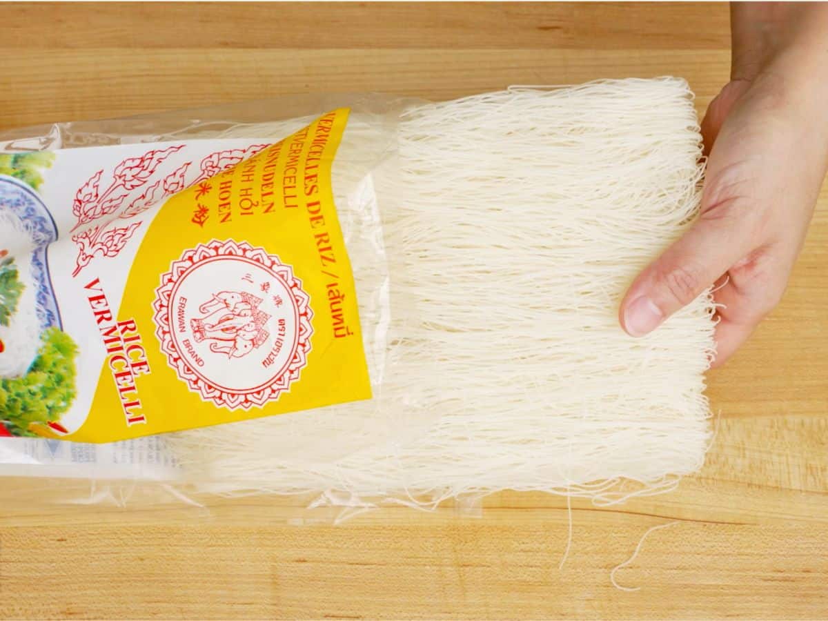 Dry rice vermicelli being pulled out of its bag
