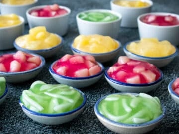 several cups of tako pudding in green, red and yellow