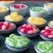 several cups of tako in green, pink and yellow. With text overlay "crystal pudding" the perfect party dessert
