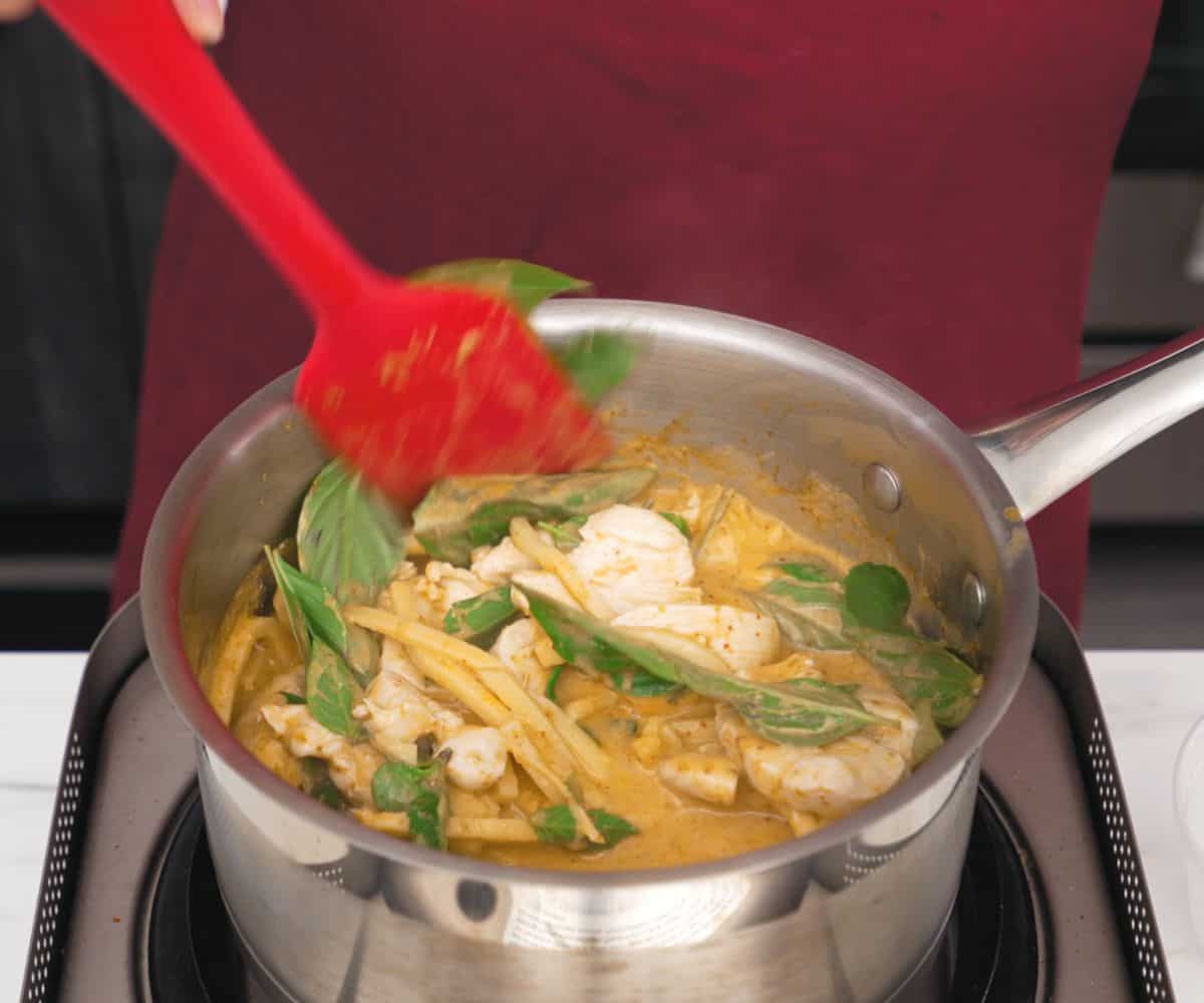 a pot of red curry chicken being made