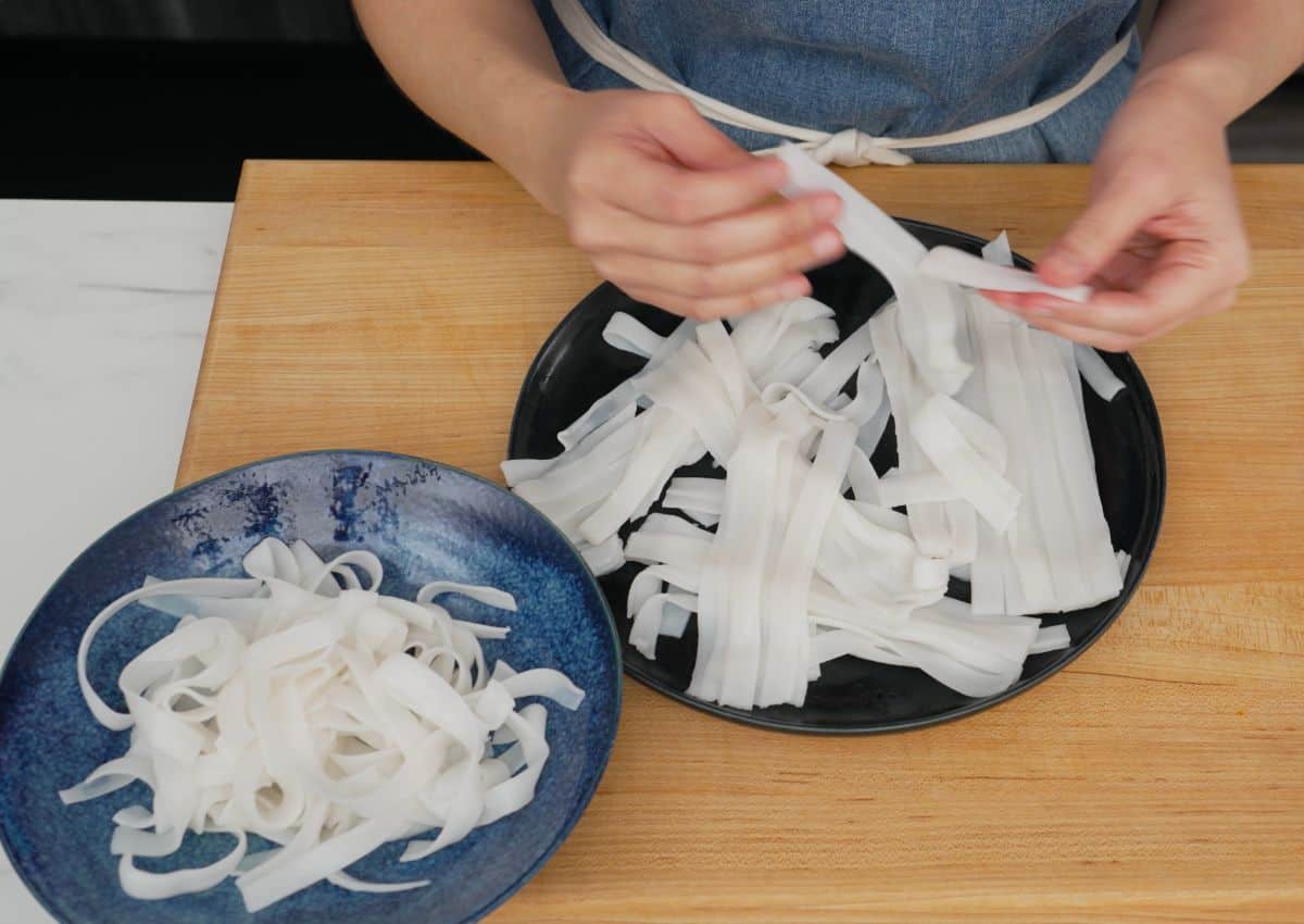 fresh rice noodles being peeled apart