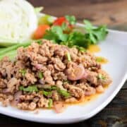 A plate of laab moo with a side of vegetables