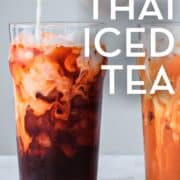 A glass of thai tea with cream being poured into it with text overlay "authentic thai iced tea"