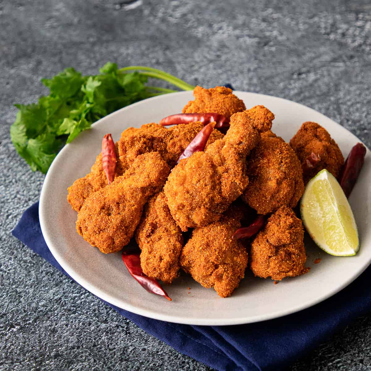 a plate of wingz zabb with a lime wedge