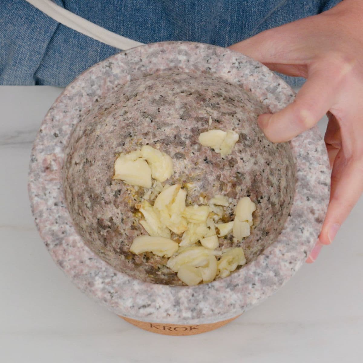 pounded chunky garlic in mortar and pestle
