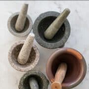 Five mortar and pestles with text overlay "ultimate guide to mortar and pestles" and "hotthaikitchen.com"