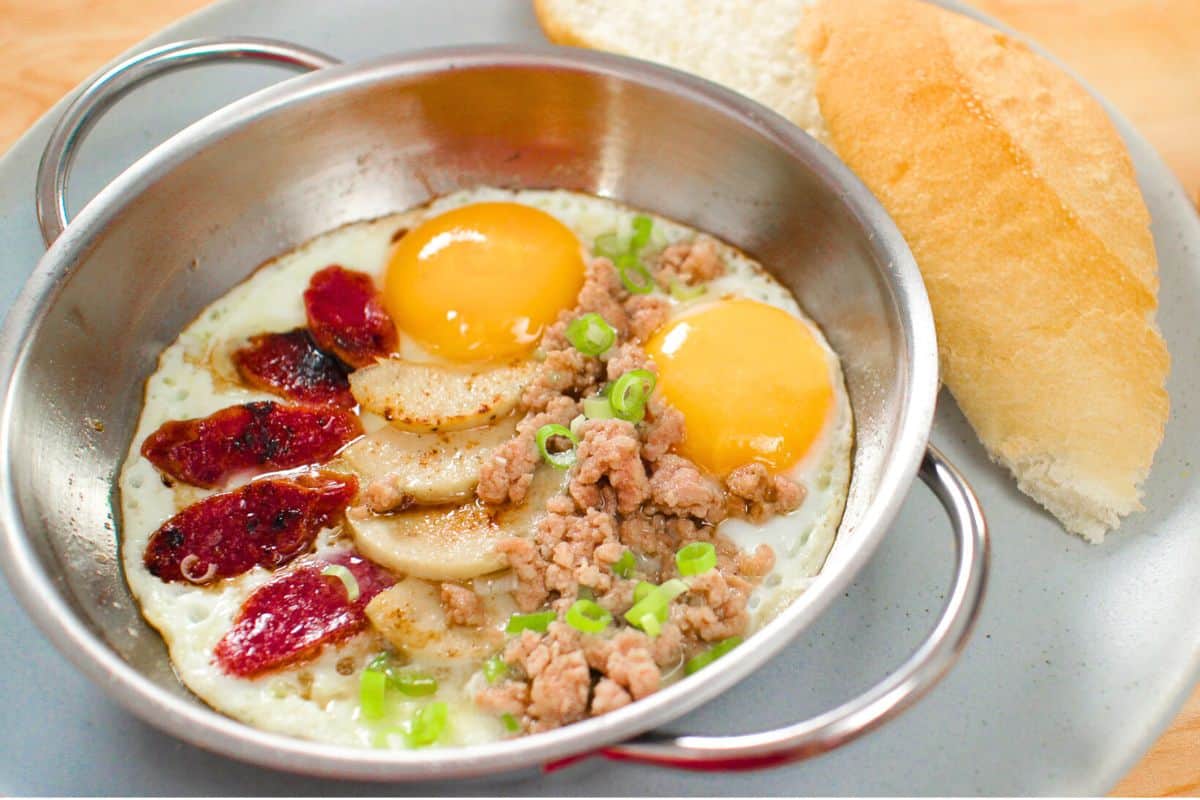 Thai pan eggs with Chinese sausage, vietnamese ham and ground pork with a side of bread.