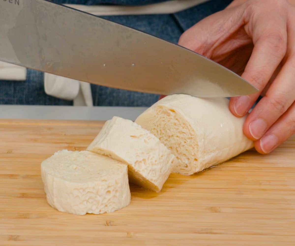 previously frozen silken tofu being sliced