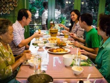 Pailin's family eating around a dinner table at a restaurant
