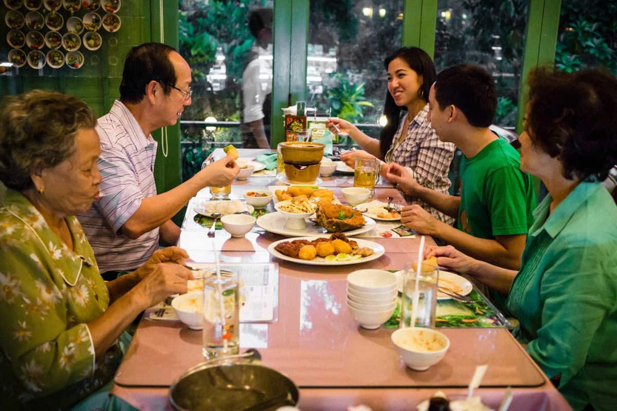 Pailin's family eating around a dinner table at a restaurant