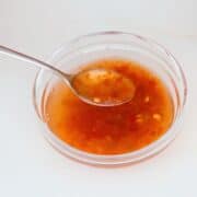 a bowl of chili vinegar with a a spoon