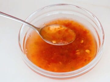 a bowl of chili vinegar with a a spoon