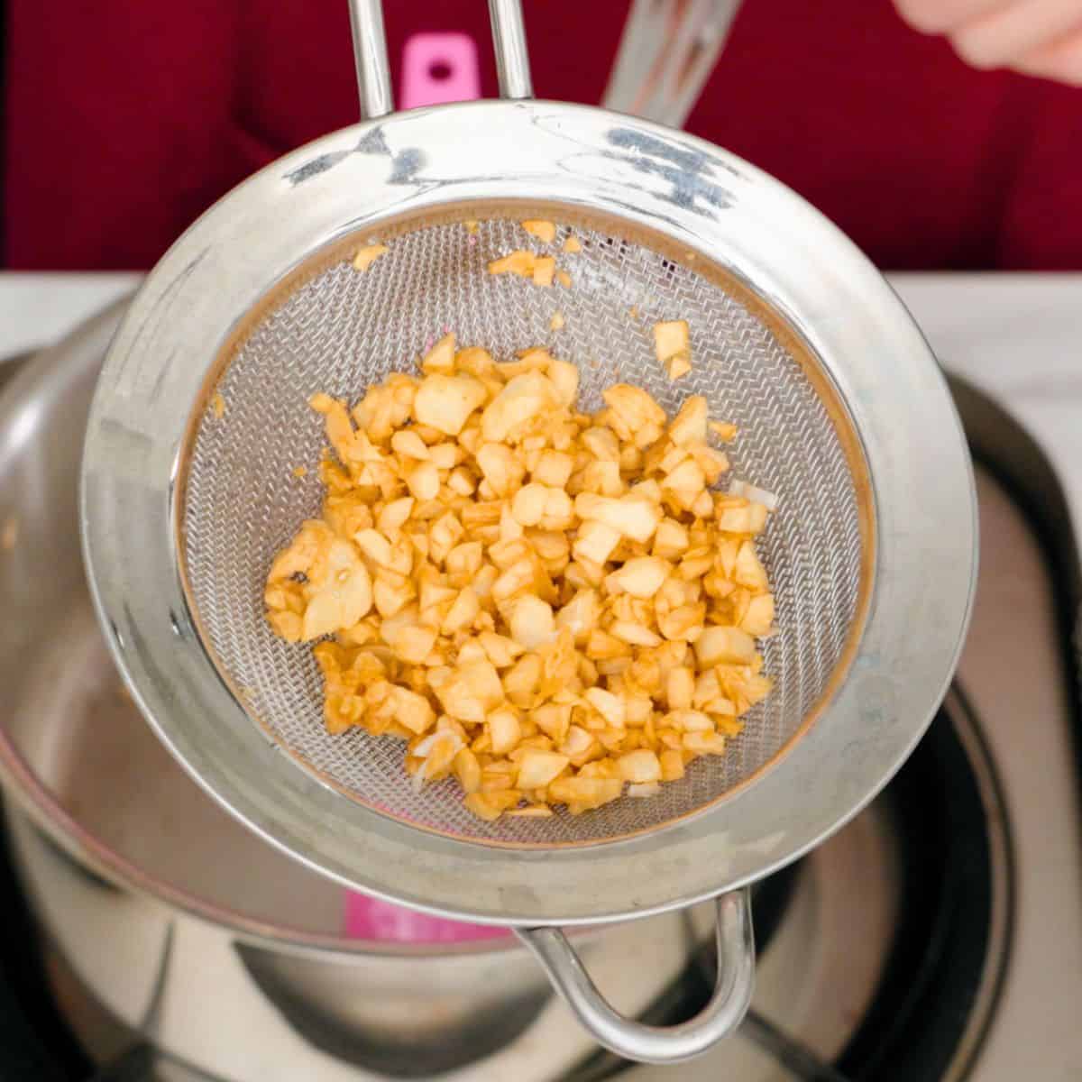 fried garlic in a sieve