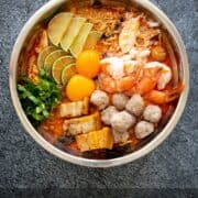 a bowl of mama tom yum noodles with toppings with text "how to dress up instant noodles"