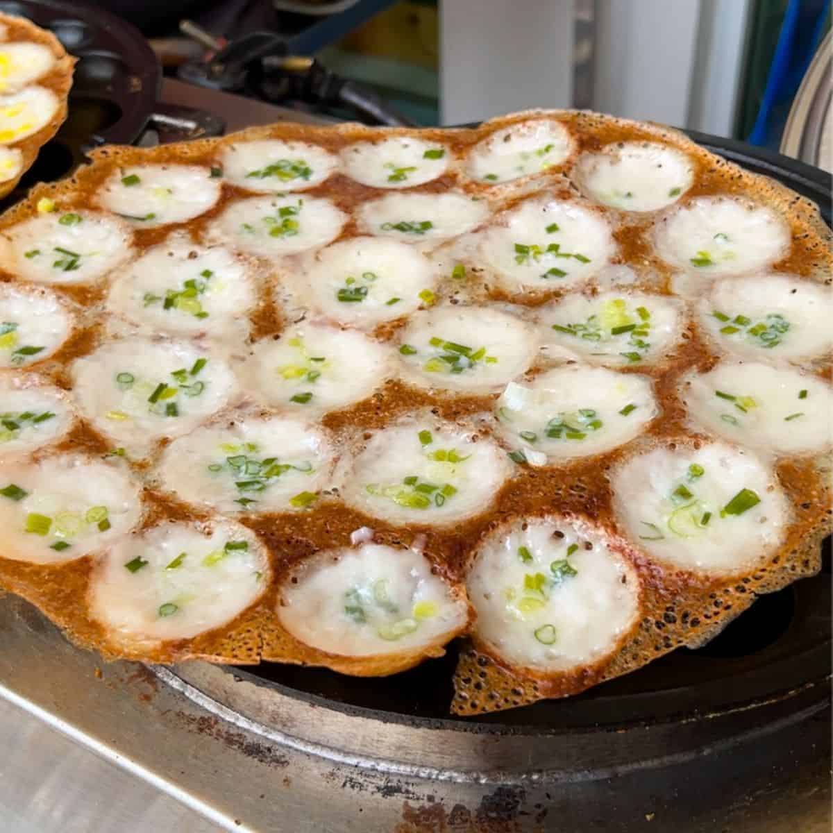 a tray of kanom krok on the stove