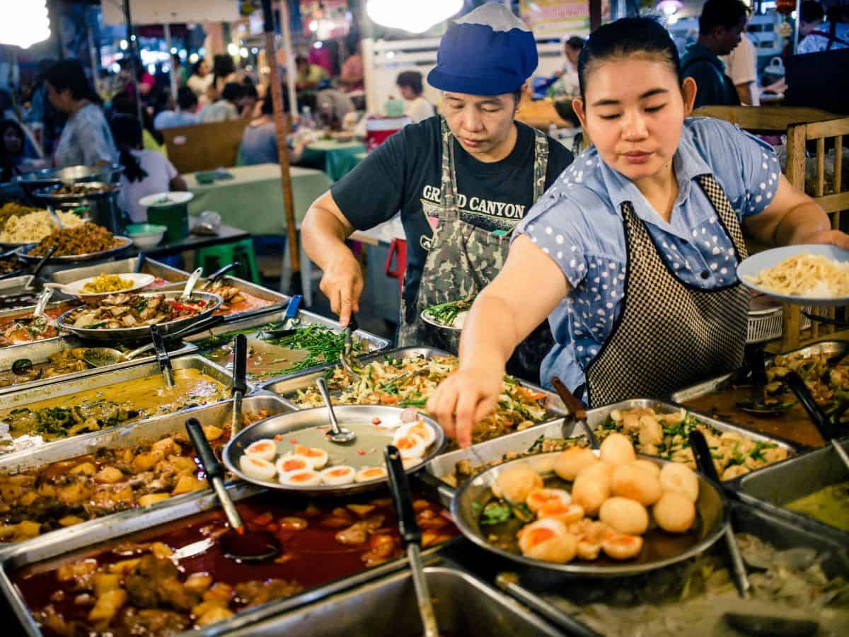 a curry rice shop in Thailand with two women serving.