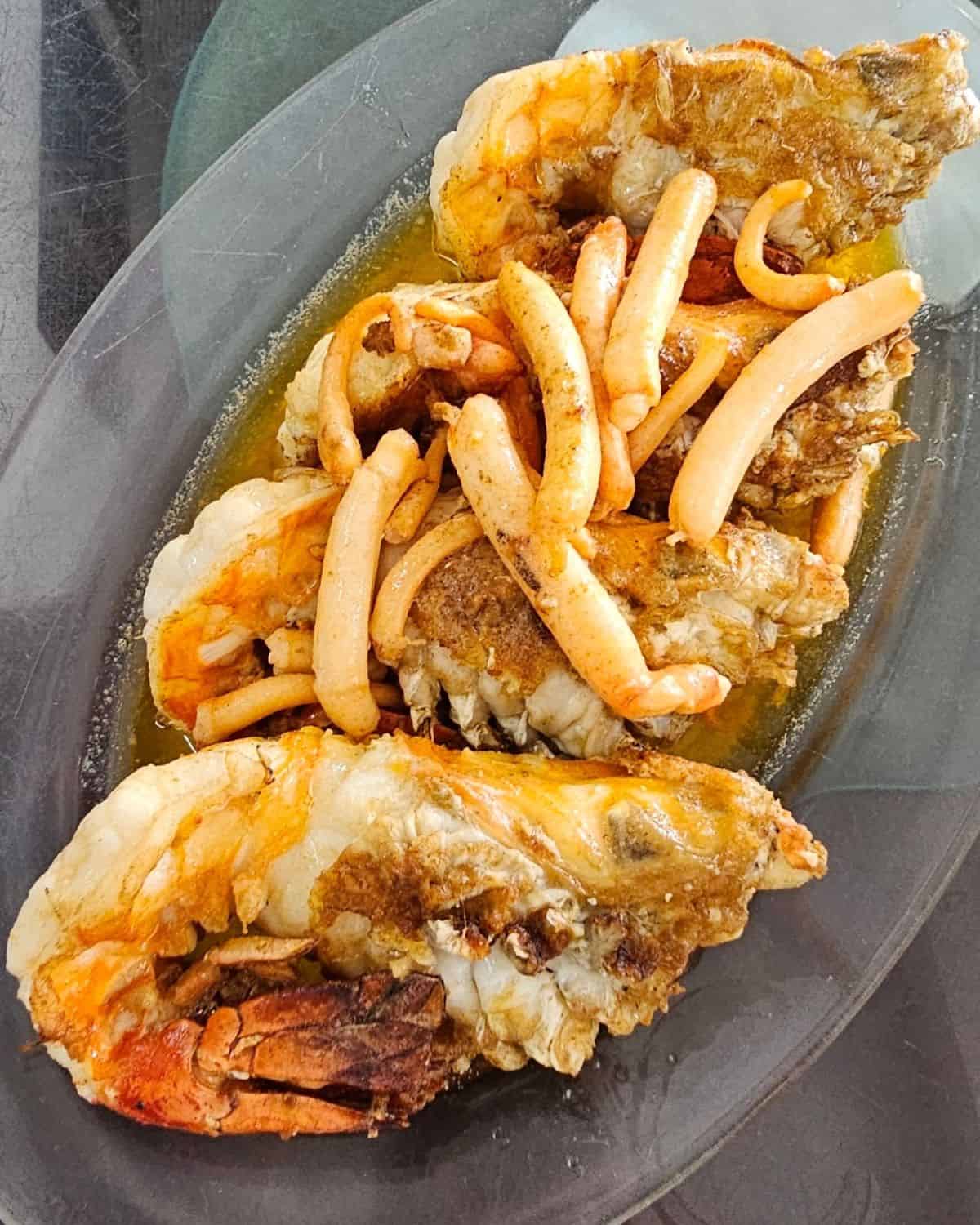 a plate of 4 cooked river prawns