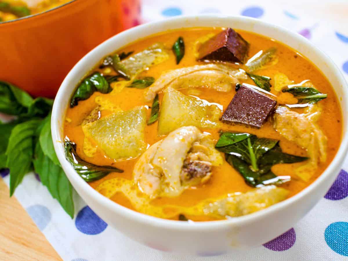 a bowl of red curry with winter melon and blood